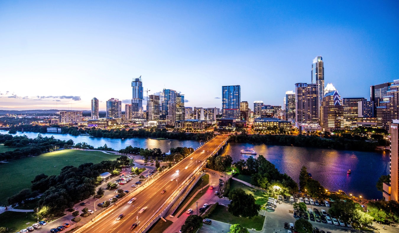 the busy skyline of Austin, Texas lit up at night