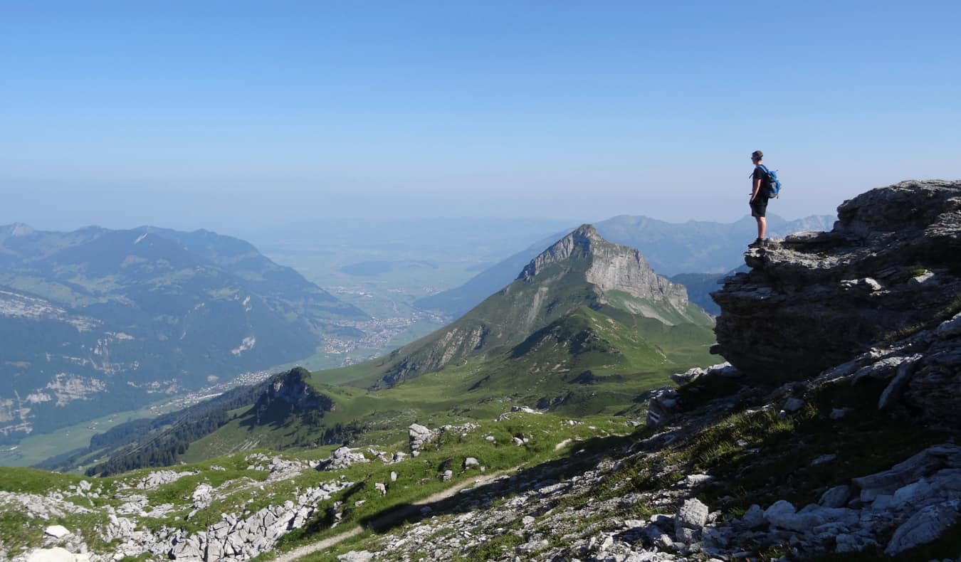 A solo traveler looking out over the mountains