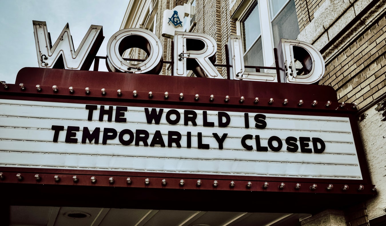 A movie theatre marquee stating the world is closed