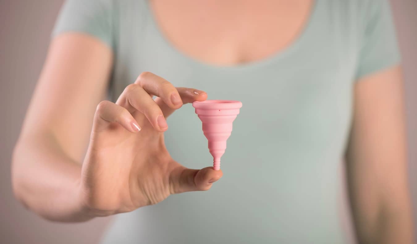 A menstrual cup stuff held by a woman