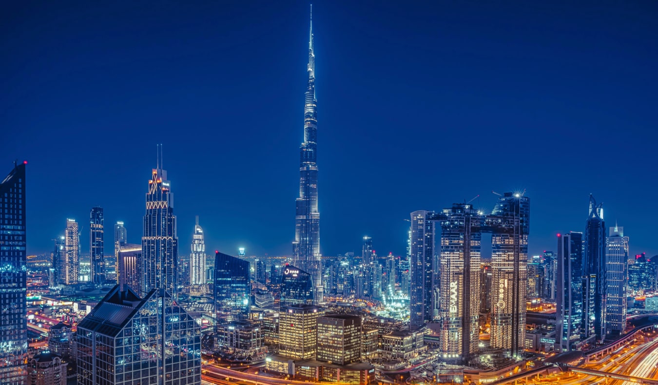 The towering and modern skyline of Dubai at night with the Burj Khalifa