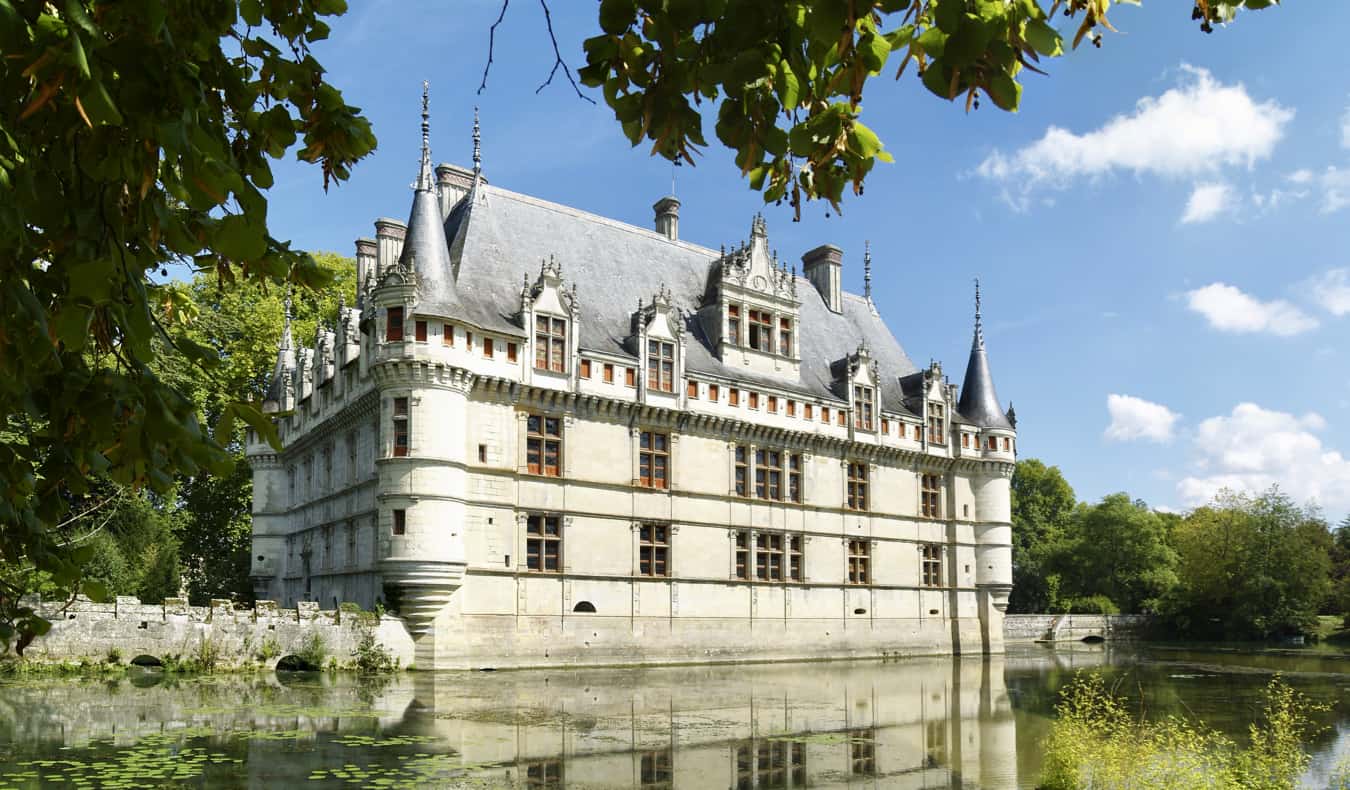 The Azay le Rideau chateau surrounded by a man-made lake in France during the summer