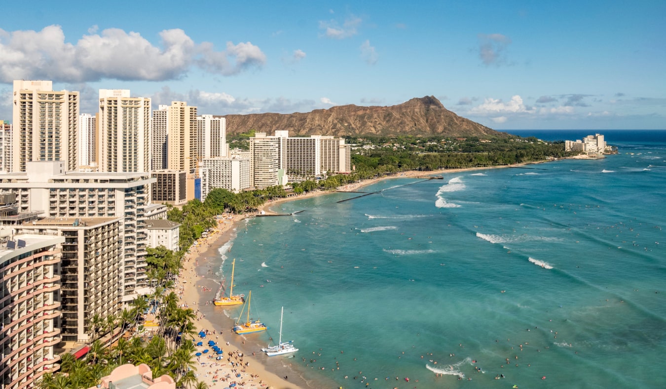 The skyline of Honolulu, Hawaii surrounded by lush forests and jungles