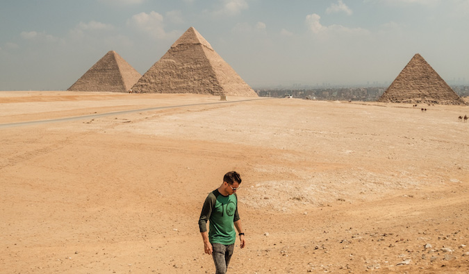 Jeremy Scott Foster posing near the pyramids in Egypt