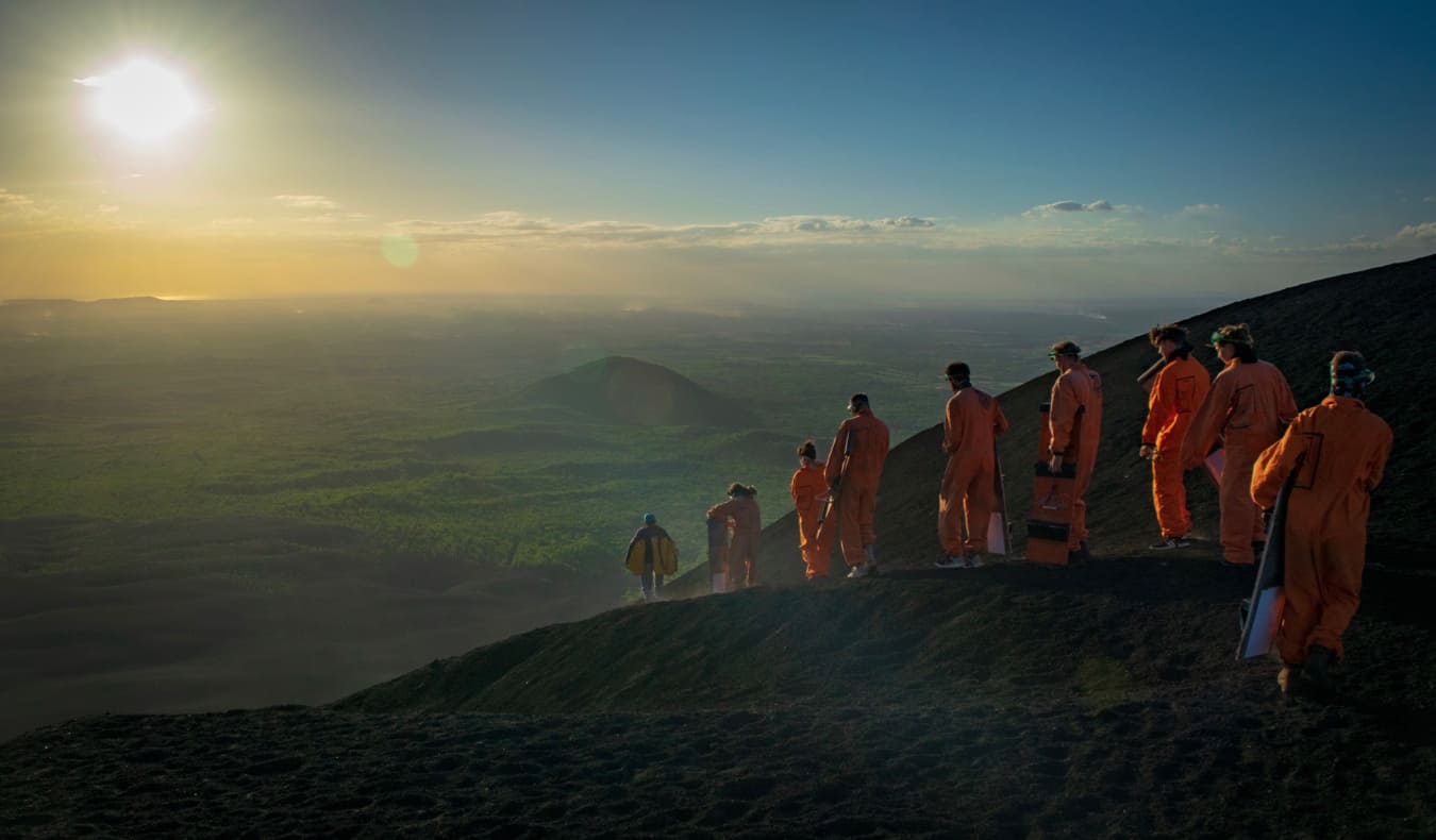 A group of people volcano boarding near Leon, Nicaragua