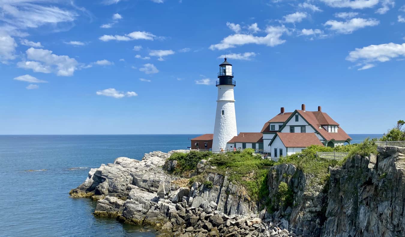 A charming lighthouse on the coast of Maine on a bright summer day