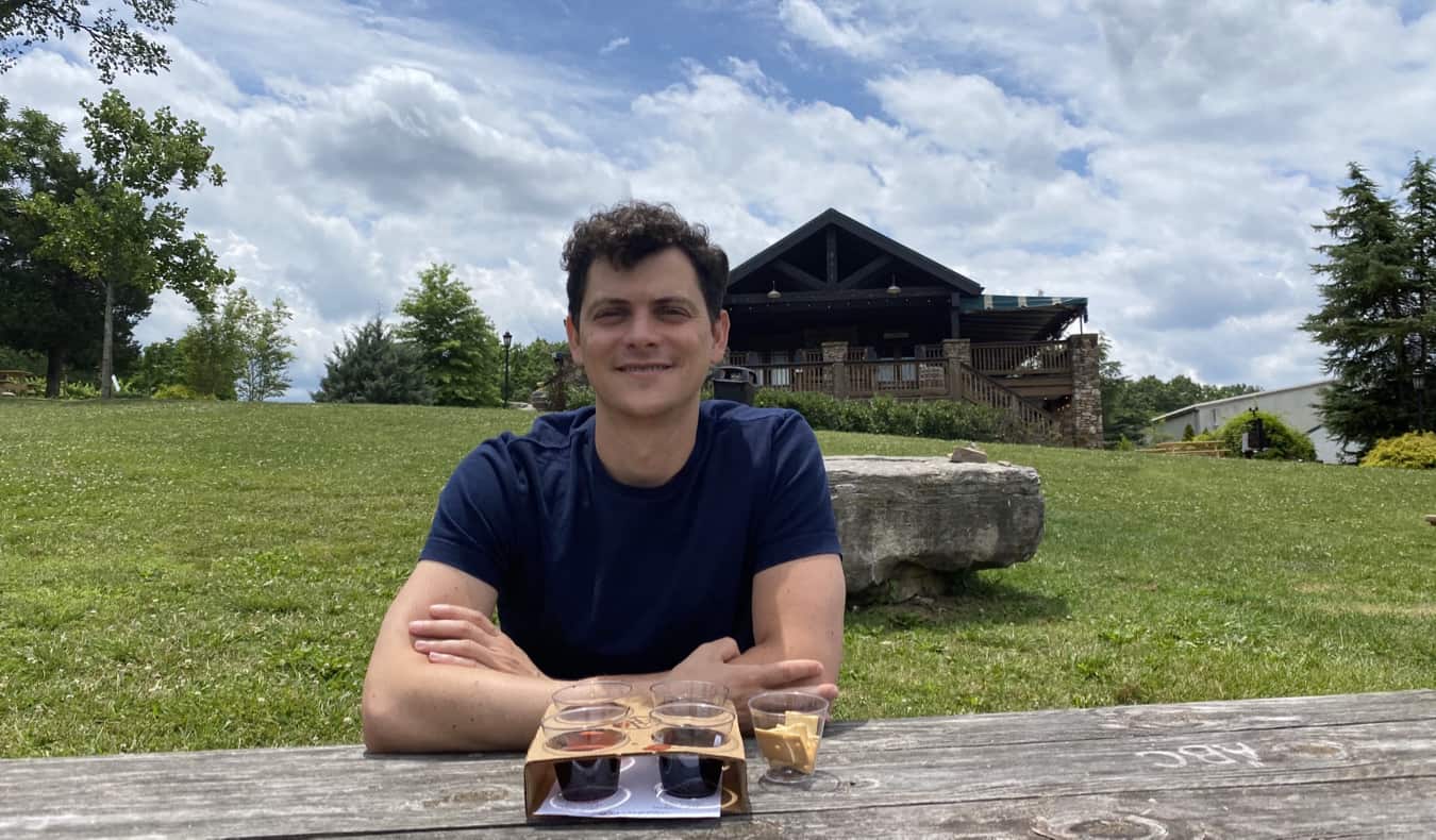 Nomadic Matt sampling beers at a picnic table