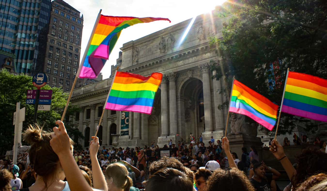 People waving gay pride flags during Pride in NYC, USA