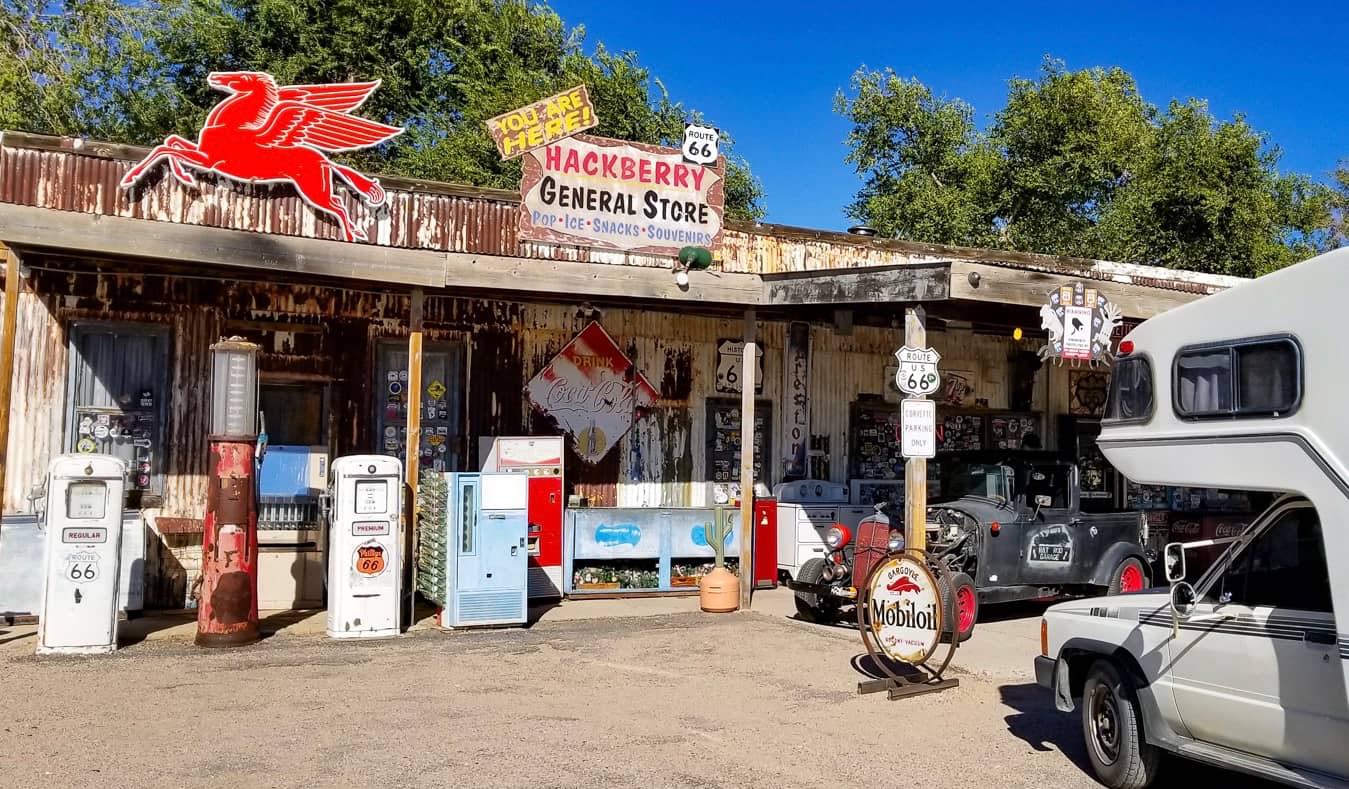 Mike and Anne from HoneyTrek parked at a small general store