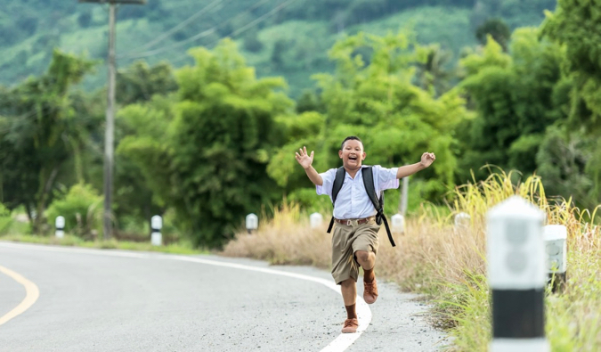 a solitary Thai student smiling for the camera