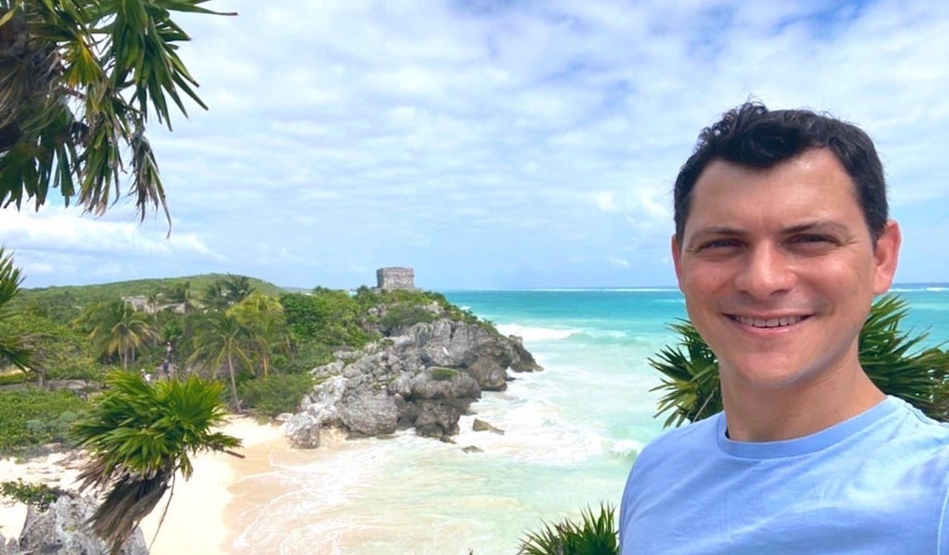 Noamdic Matt posing near ruins on the beach in Tulum, Mexico