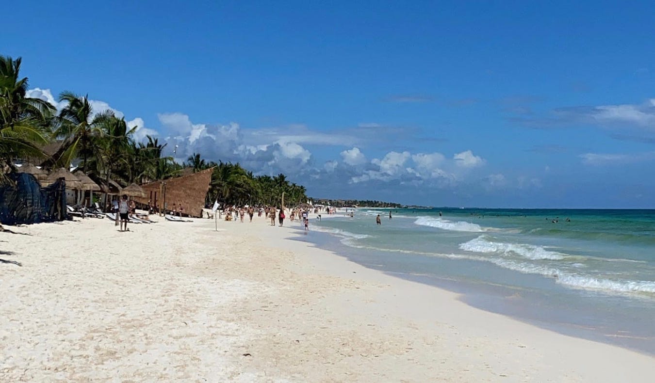 A wide beach on a sunny day in Tulum, Mexico