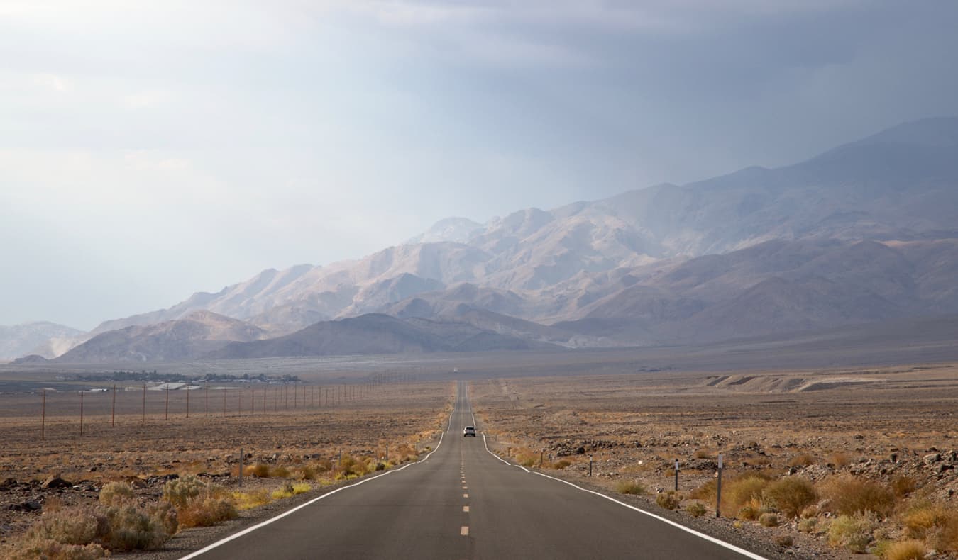 A car driving an open road in Death Valley, USA