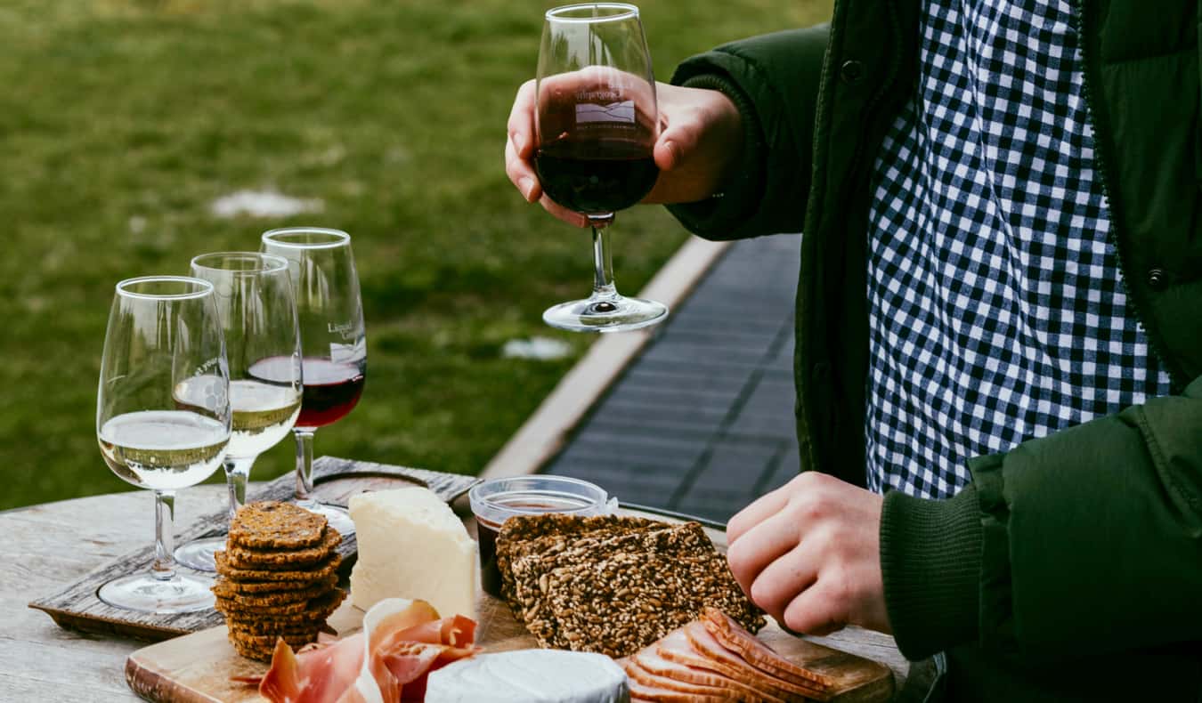 A cheese platter beside several glasses of Australian wine