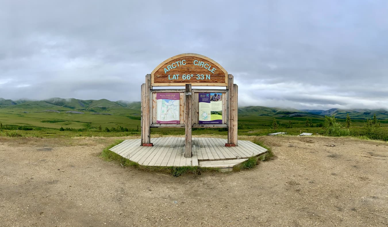 A wooden sign declaring the Arctic Circle in Yukon, Canada