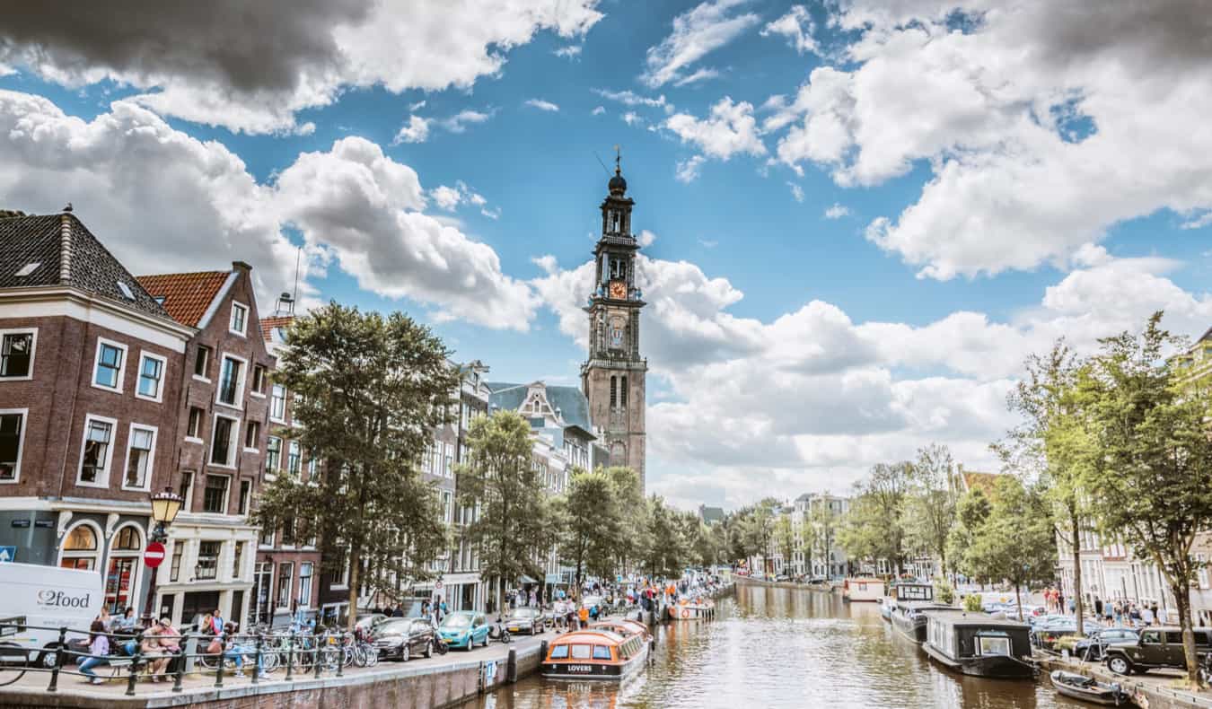 A canal in Jordaan, Amsterdam in summer, lined with houseboats.