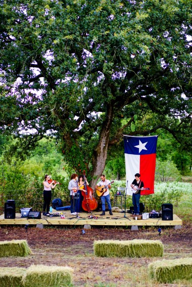 band playing in front of a Texas flag