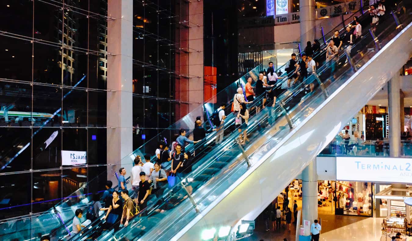 Locals and tourists shopping at a busy mall in Bangkok, Thailand