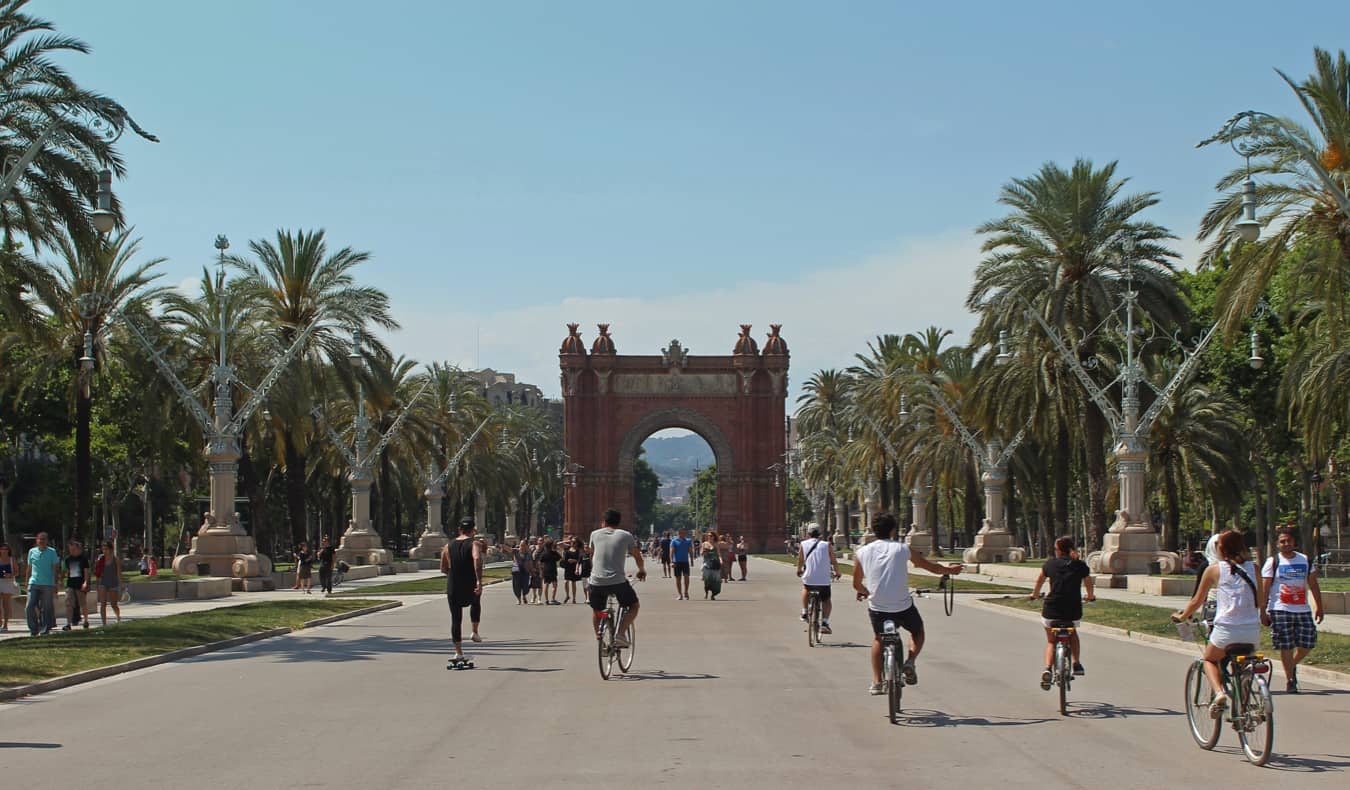 People riding bikes around Barcelona, Spain in summer