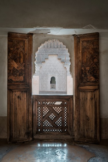 ornamental wooden door and archway at Ben Youssef Madrasa