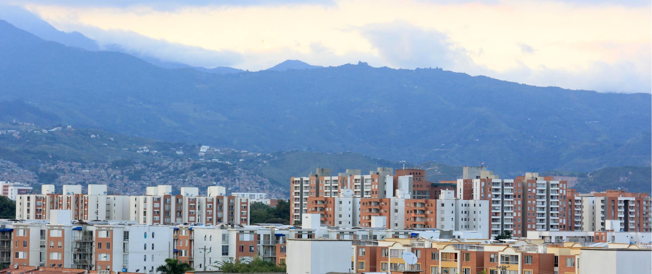 The skyline of Cali, Colombia with towering mountains in the distance