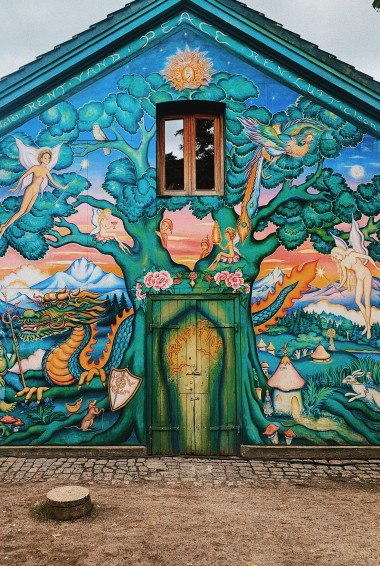 building painted with a large tree and fairies