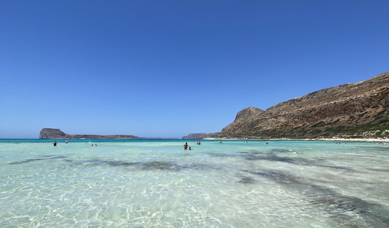 A clear, calm beach in Crete on a sunny day