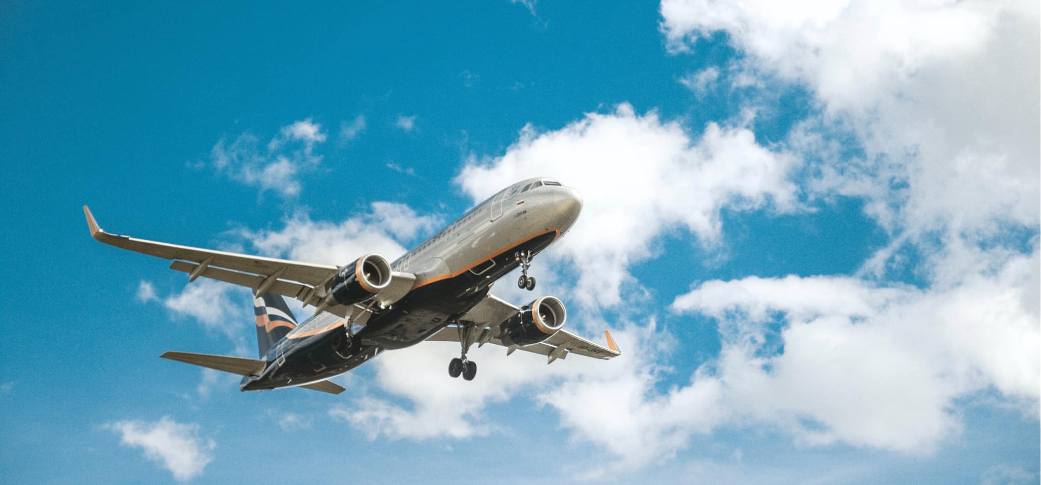 A commercial airplane landing at an airport on a bright summer day