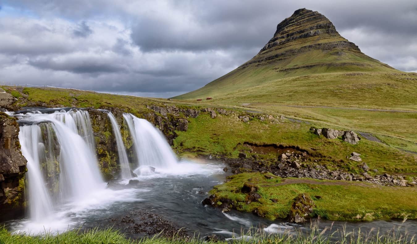 green mountain and waterfall in Iceland