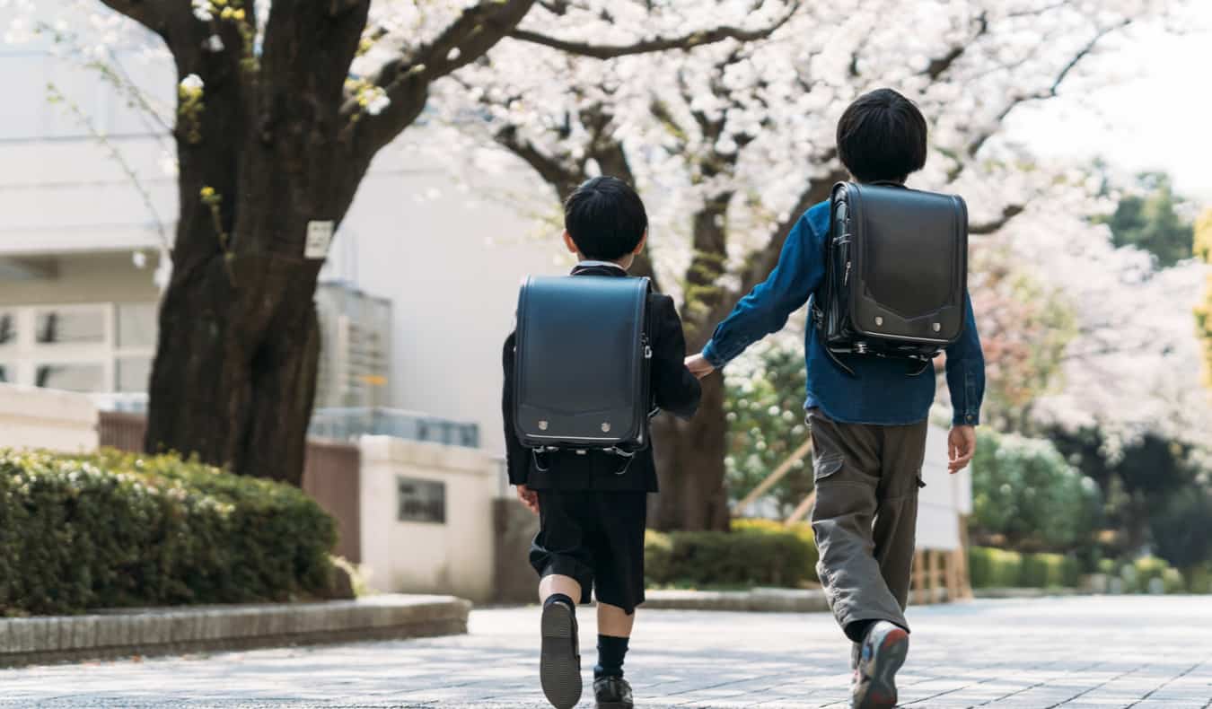 Two young students walking to school in Japan