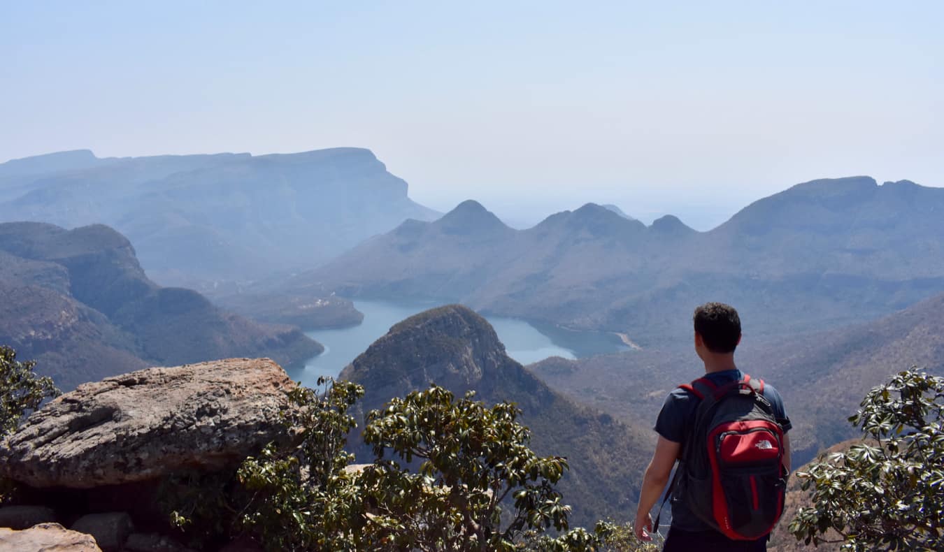 Nomadic Matt hiking in Africa looking out over the distant mountains