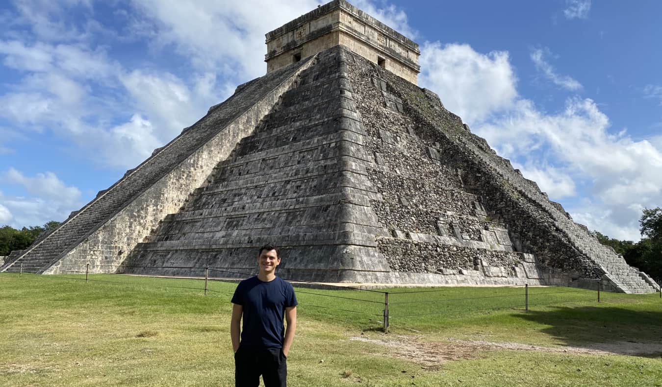 Nomadic Matt posing for a photo near Chichen Itza in Mexico