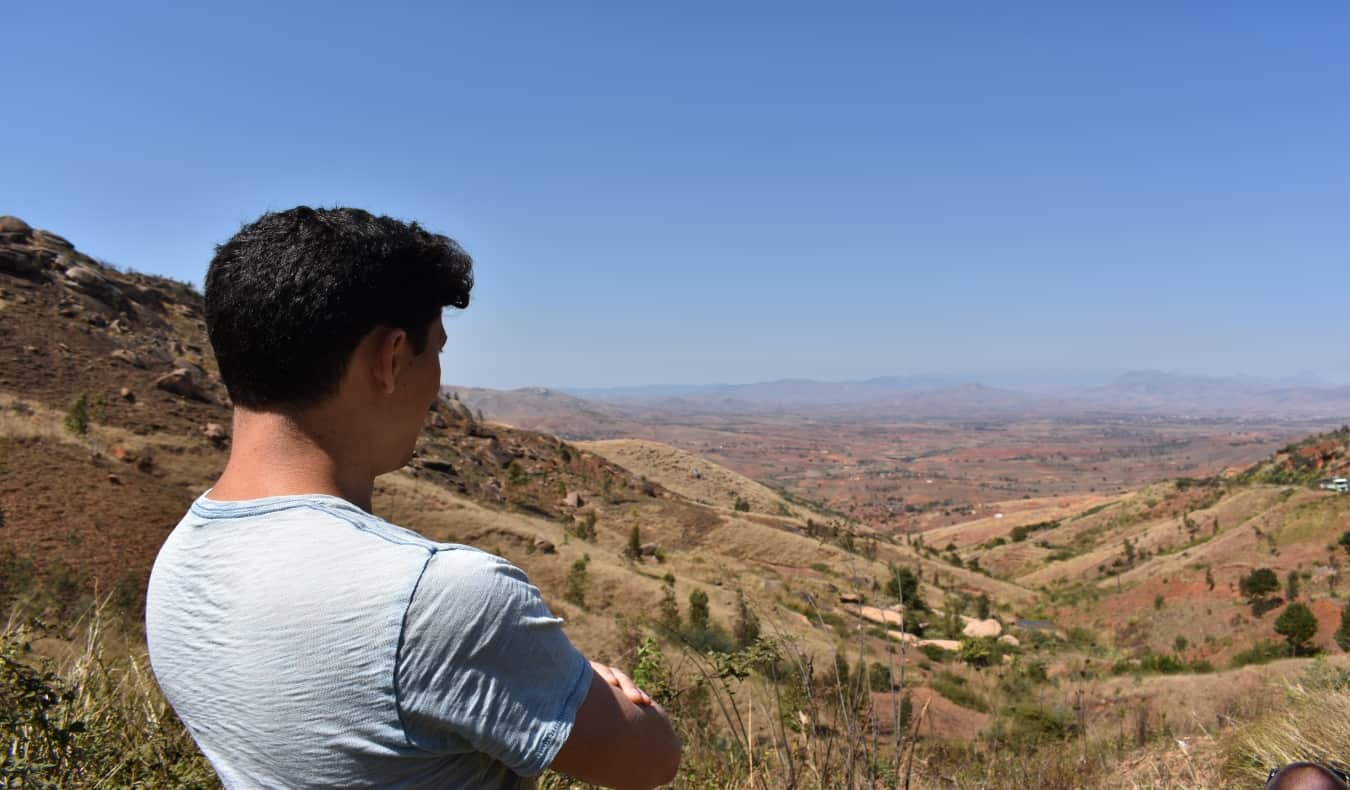 Nomadic Matt looking out over valley in Africa
