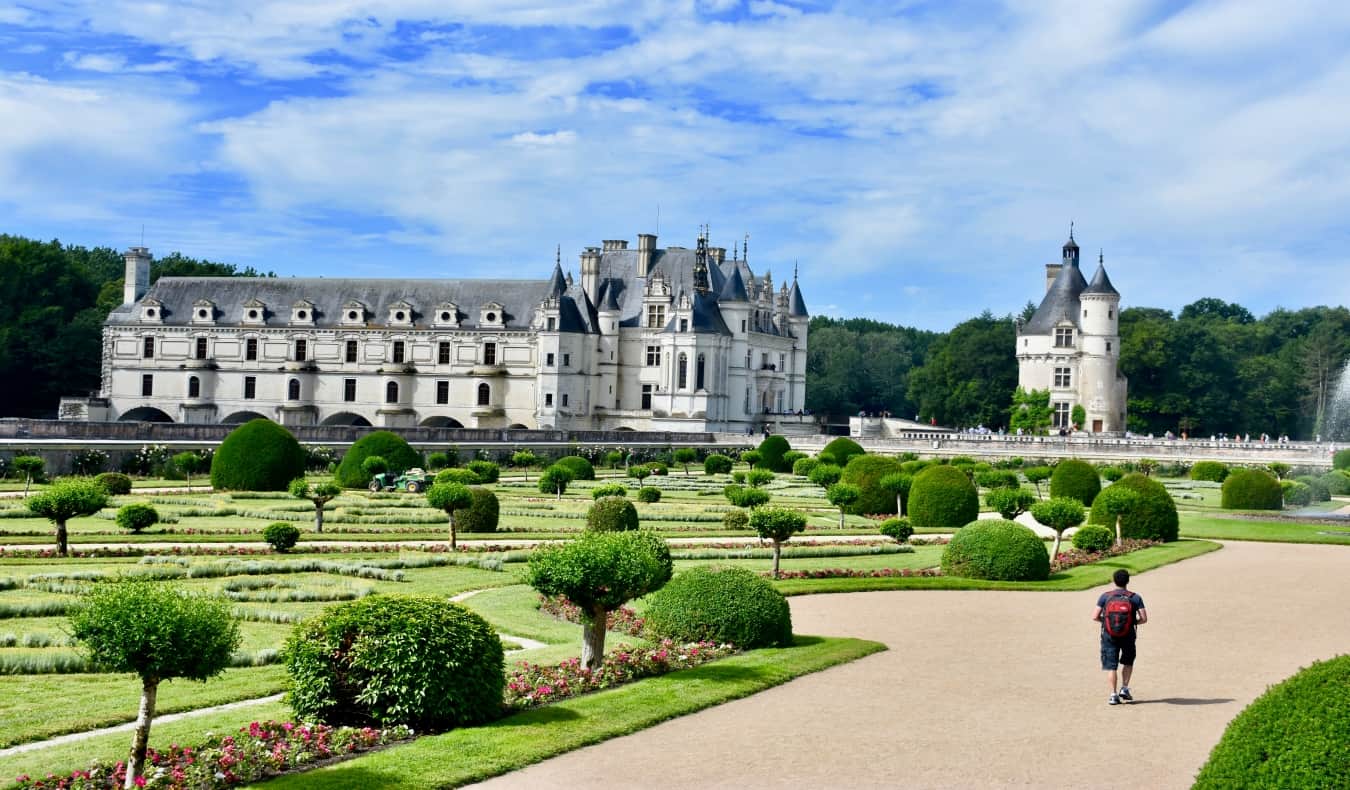 Nomadic Matt walking in castle gardens in France