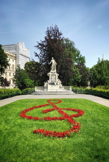 Mozart statue with flowers in shape of treble clef