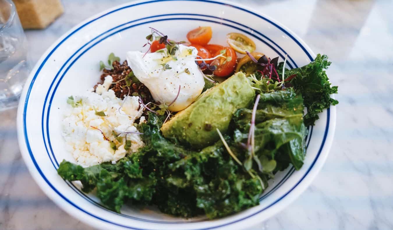 Bottomless brunch in New York City, featuring a plate of salad and a poached egg
