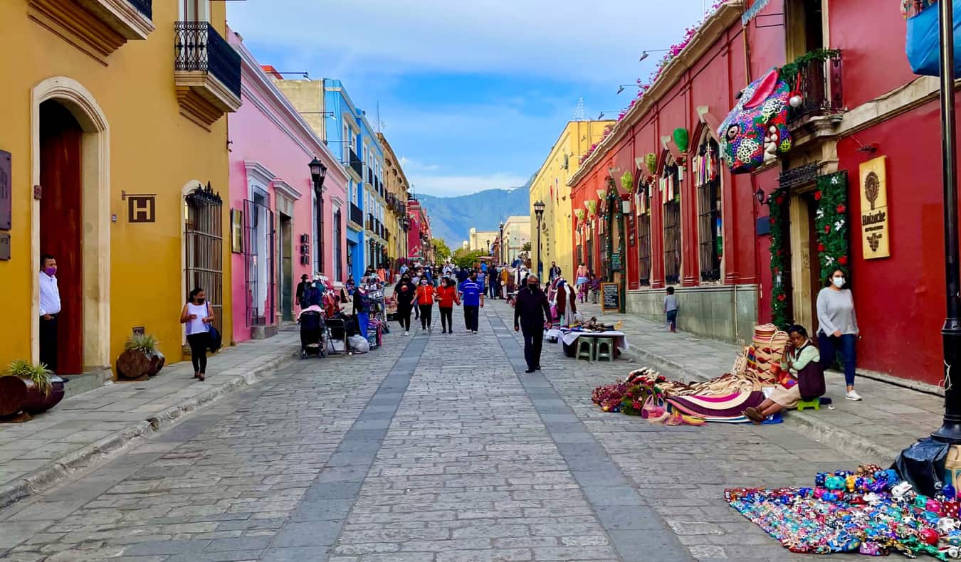 People selling goods on a quiet street in Oaxaca, Mexico