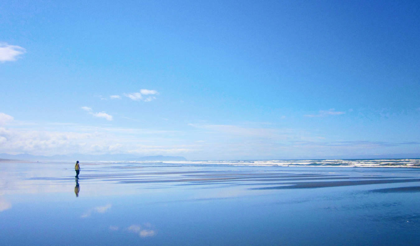 A lone woman on Seaside beach in Oregon, USA