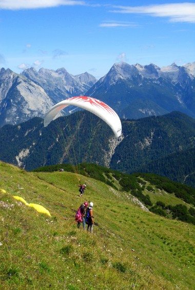 Paragliders with mountains in background