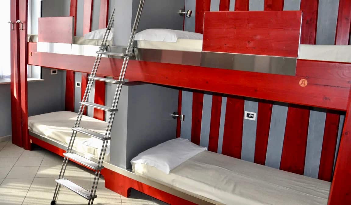 The red bunks in a dorm room in the Roma Scout Center hostel in Rome, Italy