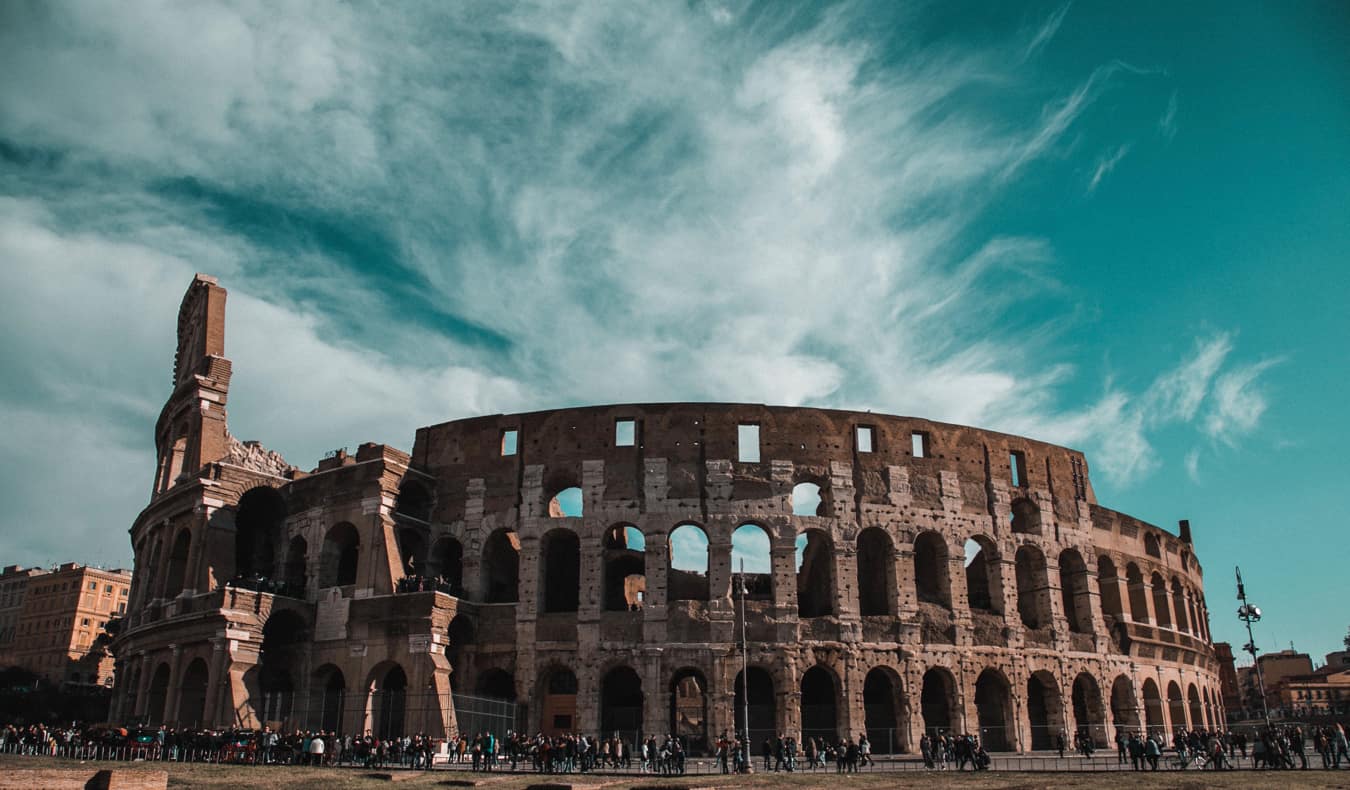 The ancient Roman Coliseum set against a blue sky in summer in Rome, Italy