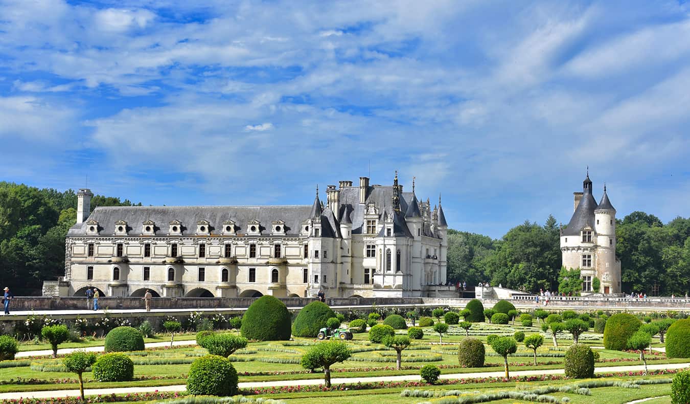 A chateaux in France and the surrounding gardens on a beautiful summer day