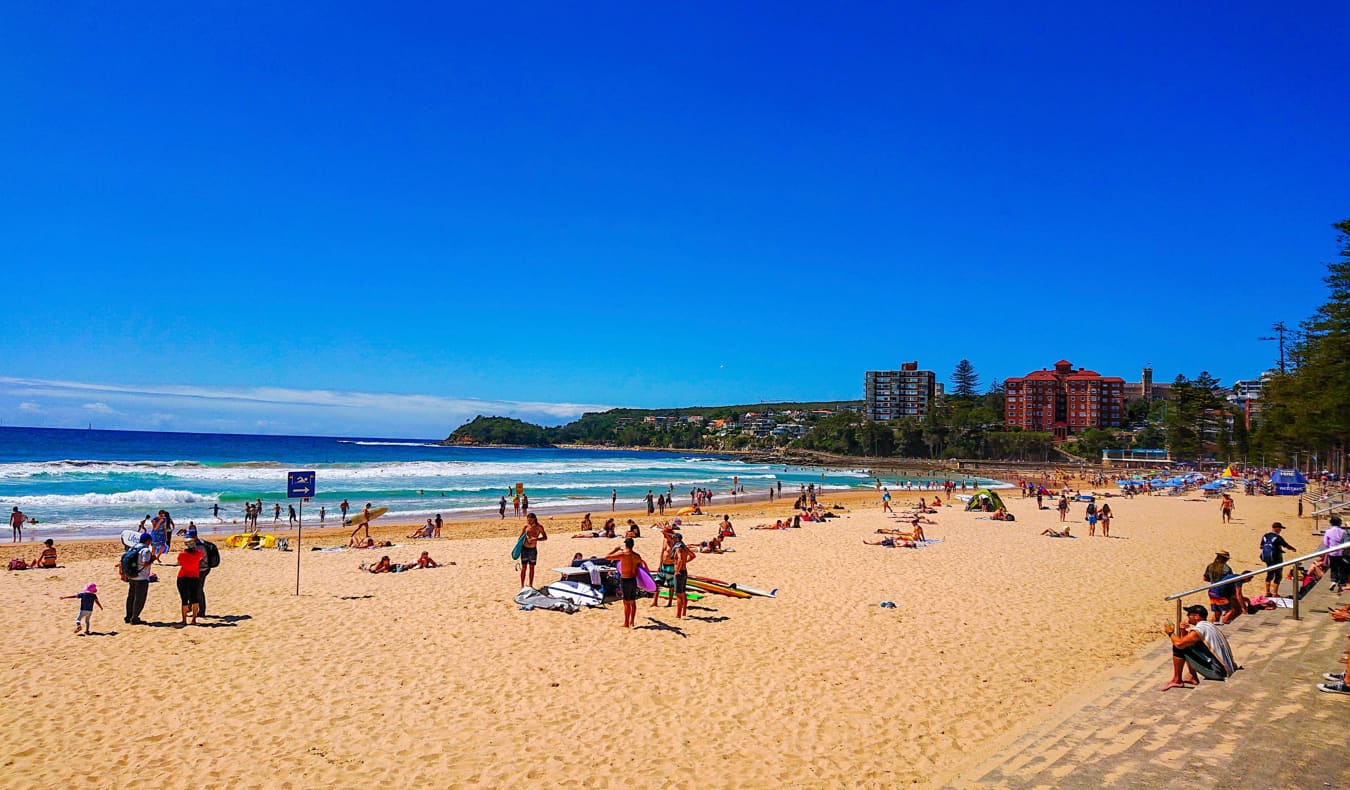 People enjoying Manly beach on a sunny day in Australia