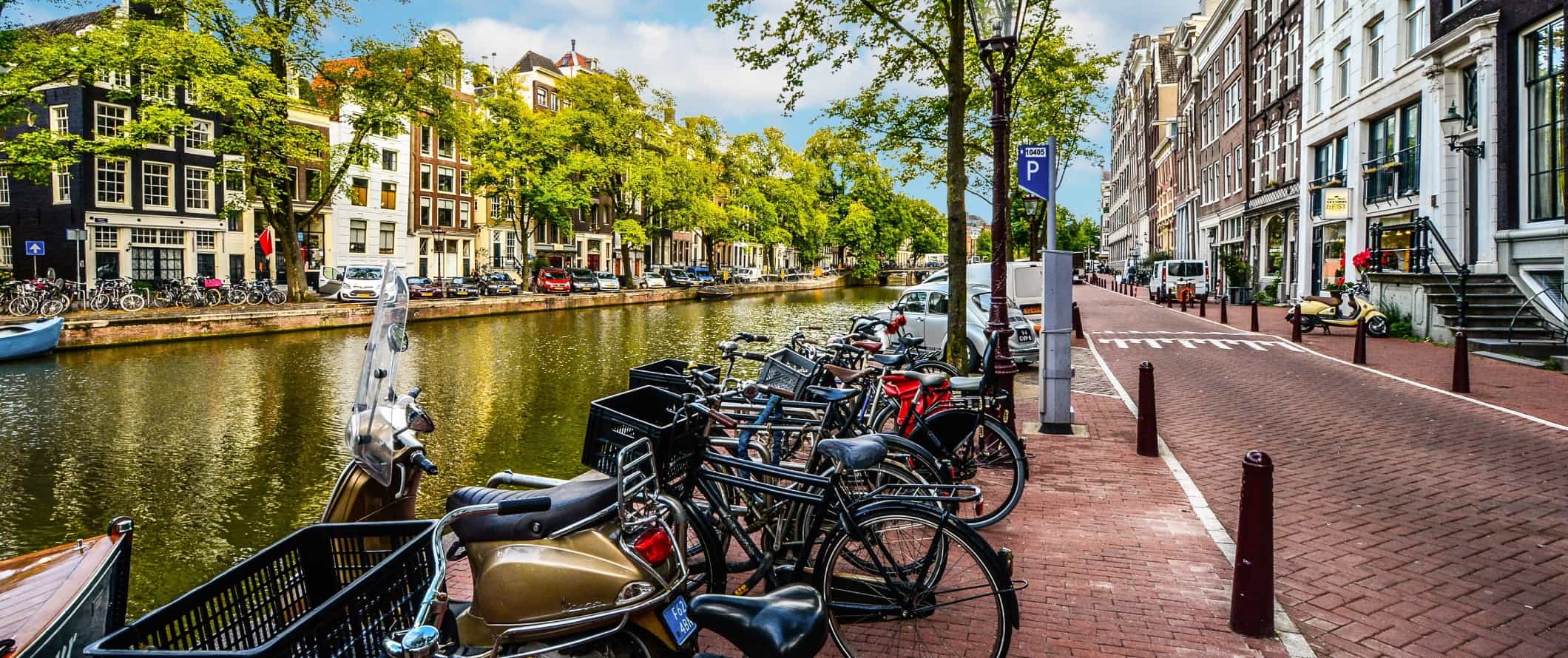 Cluster of bikes locked up along a canal in Amsterdam, the Netherlands.