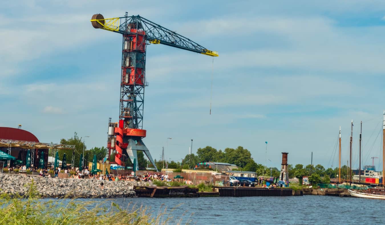 A towering crane overlooking the water at the NDSM Wharf in Amsterdam, Netherlands