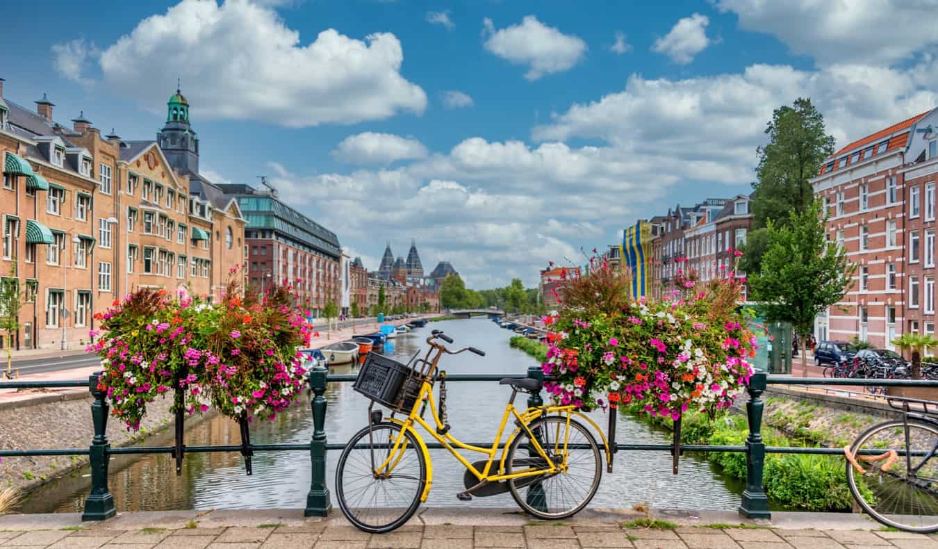 A bike leaning against the railing of the iconic canals in Amsterdam, Netherlands