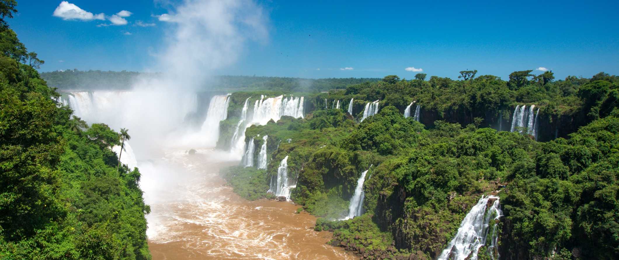 The waterfalls of Iguazu Falls, surrounded by lush greenery, in Argentina