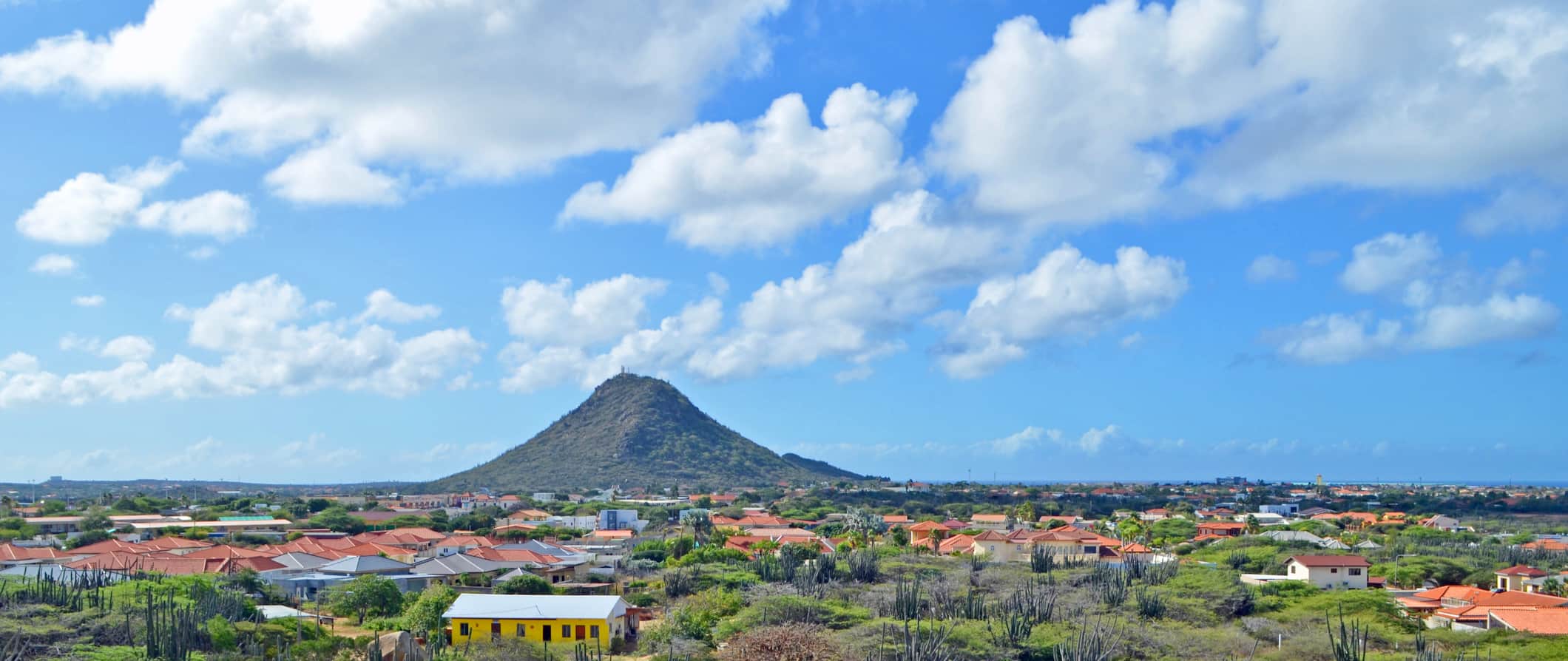 The lone Hooiberg hill towering in the distance on Aruba