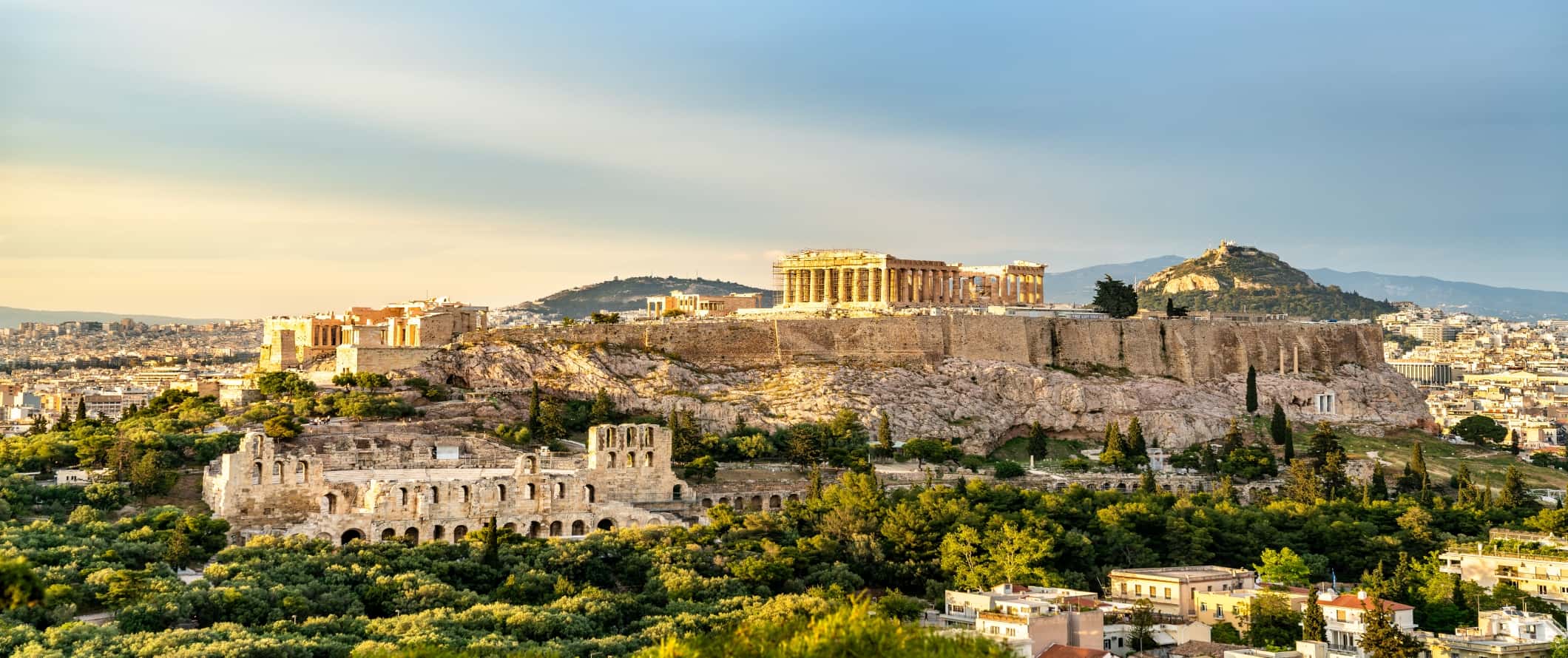 Panoramic view of the Acropolis on a hill with other historical ruins around in Athens, Greece