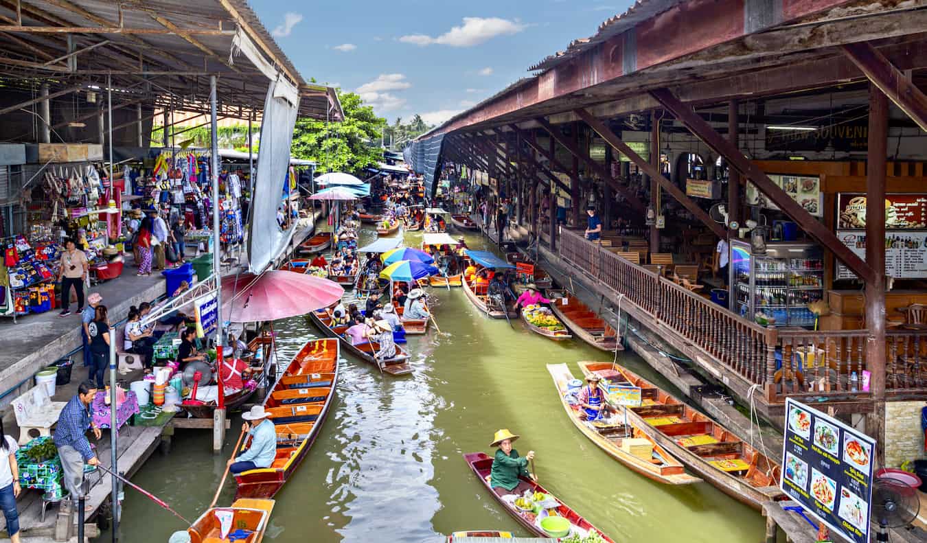 The famous Floating Market in Bangkok, Thailand with lots of small boats selling goods to tourists